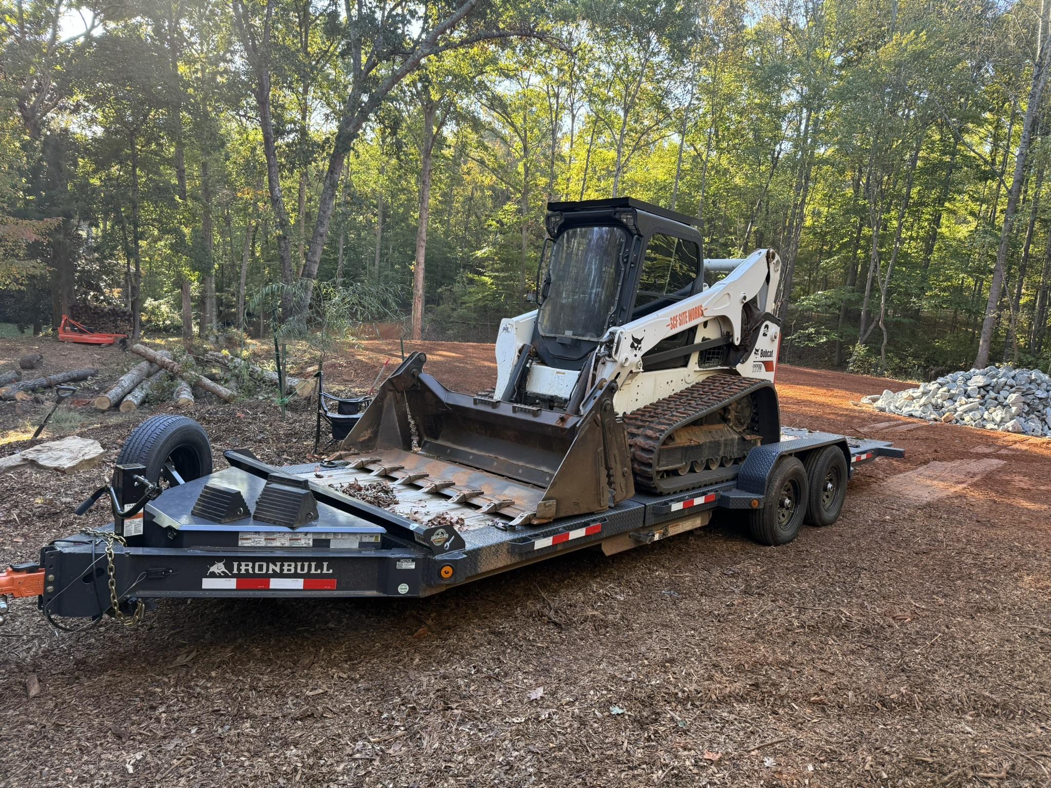 IronBull tilt deck trailer hauling Bobcat skid steer in Waxhaw NC - Professional equipment trailer rental